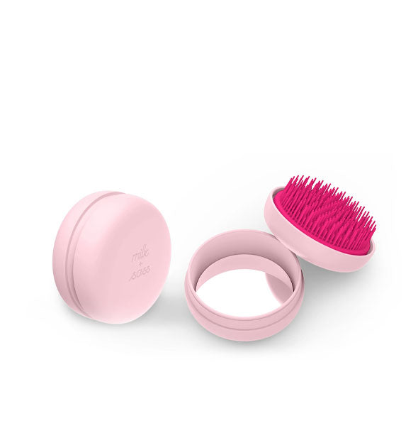 Light pink Macaron Hairbrush shown closed and opened to reveal the mirror and dark pink bristles inside