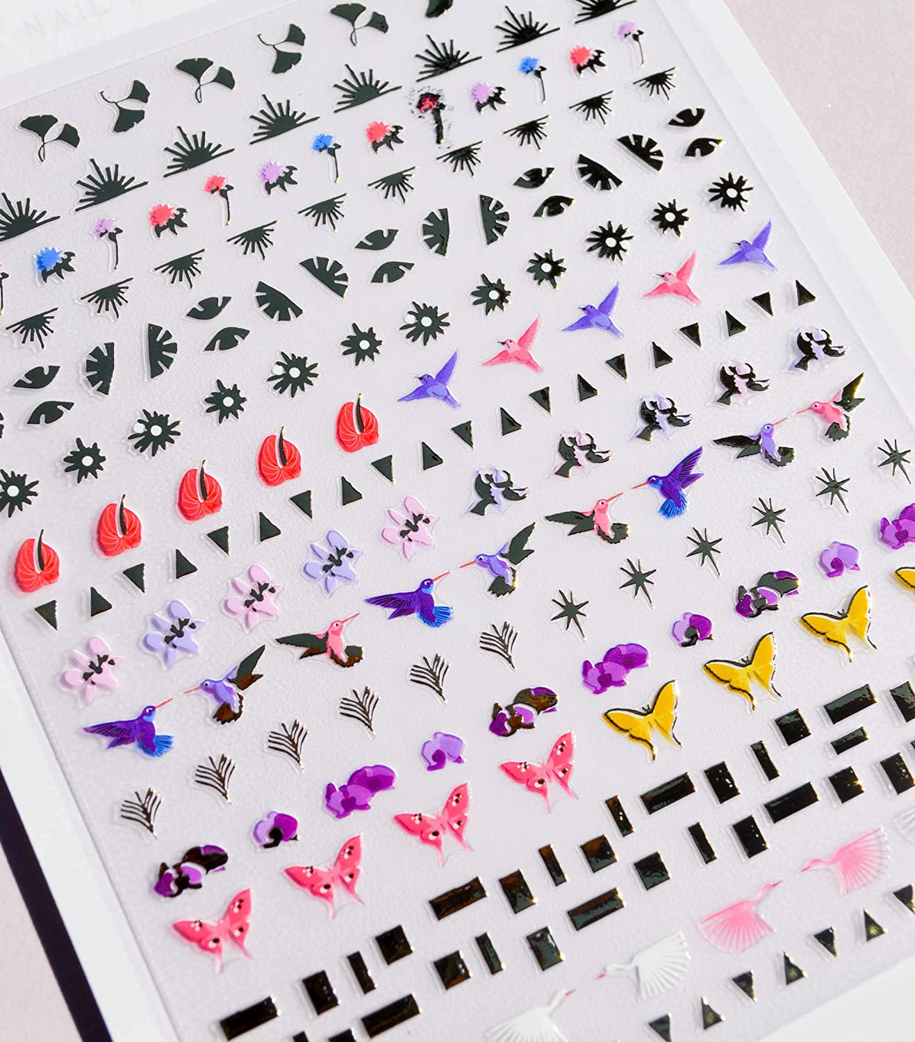 Closeup of Deco Miami Nail Art Stickers pack shows butterfly, floral, and bird designs