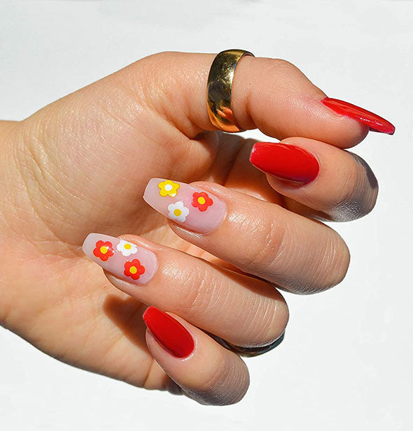 Model wears red and pink nail designs with floral accents