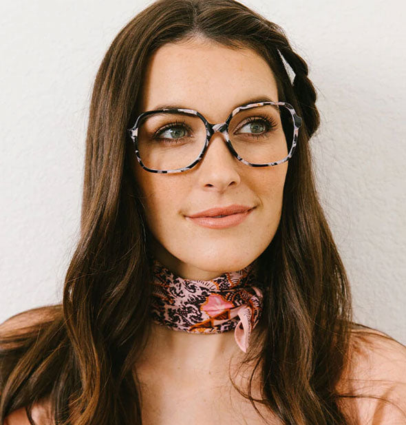 Model wears a pair of squarish flecked glasses