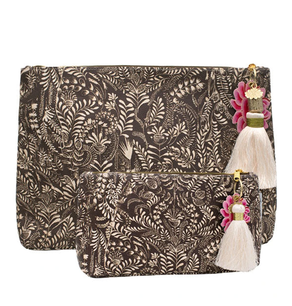 Small and Large pouches with intricate floral brushstroke design and white tassels hanging from gold zippers