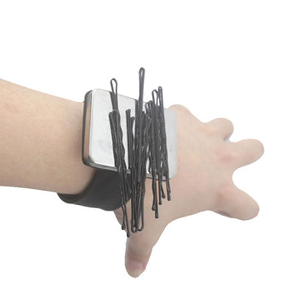 Model wears a Magnetic Bobby Pin Holder wrist band with metal bobby pins attached to demonstrate use