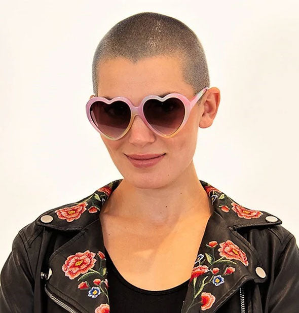 Model wears a pair of heart-shaped sunglasses