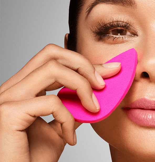 Model demonstrates use of a pink facial blotting sponge