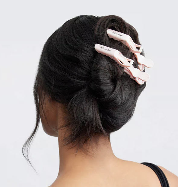 Model wears two light pink Kitsch crocodile clips in a twisted-up style