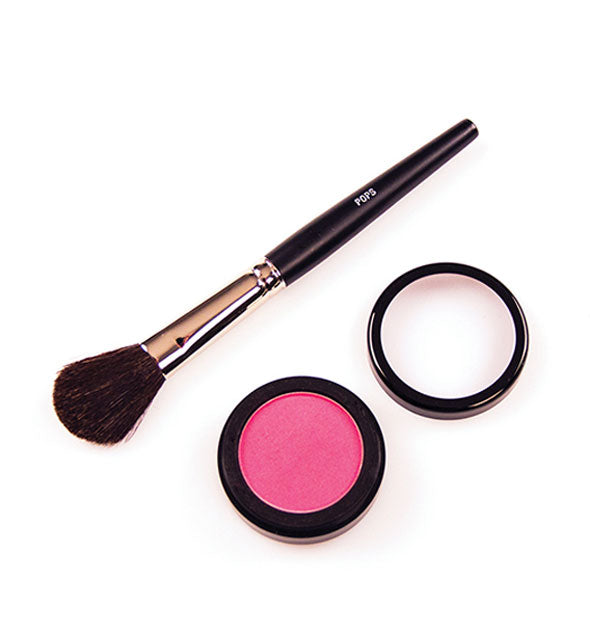 A blush brush next to a round blush compact with lid removed