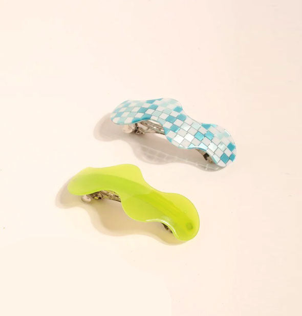 Two wavy hair barrettes, one in translucent lime green and the other in a slightly iridescent blue and white checker print