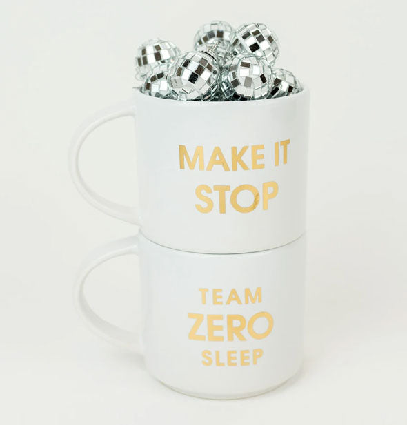 Make It Stop Mug with mini disco balls in it is stacked on top of the Team Zero Sleep Mug
