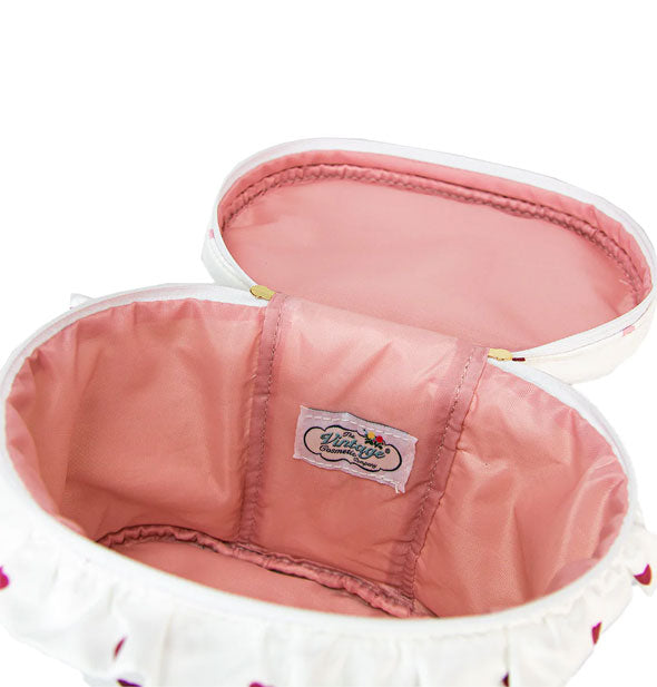 Open round case with plush pink lining and sewn-in Vintage Cosmetic Company label