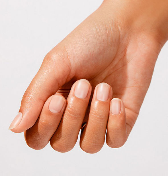 Model's hand wears a matte-finish application of nail strengthener