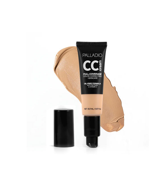 Tube of Palladio CC Cream Full-Coverage Color Correcting +Skincare in a medium shade with cap removed sample swatch behind