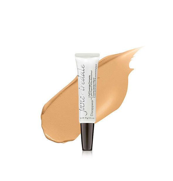 Tube of Jane Iredale Disappear Full Coverage Concealer with color swatch behind in the shade Medium