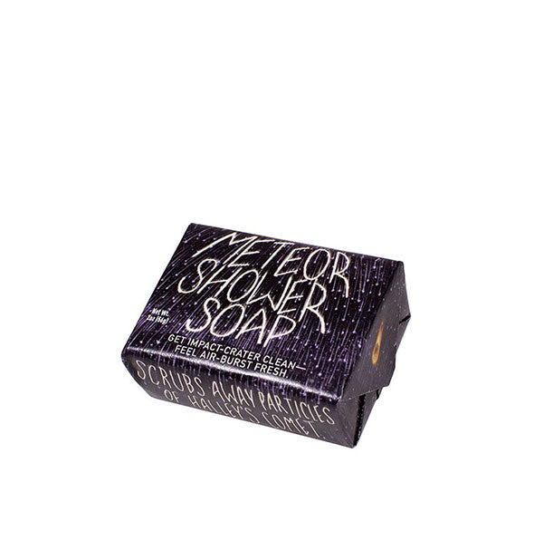 Bar of Meteor Shower Soap is wrapped in black paper accented by shooting stars and featuring white lettering