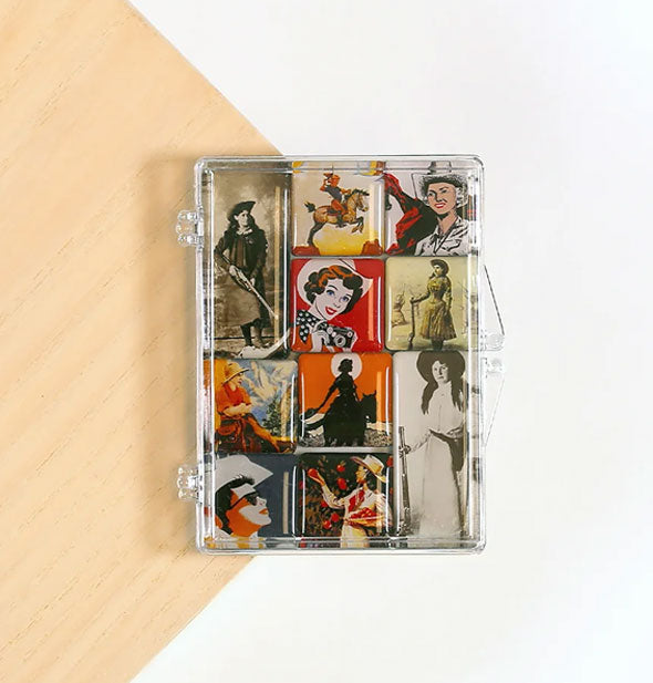 Set of 10 magnets with images of vintage cowgirls in clear jewel case on white and wood surface