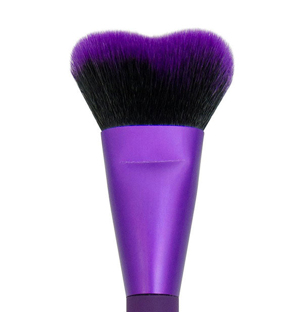 Closeup of purple makeup brush with unique heart-shaped bristles