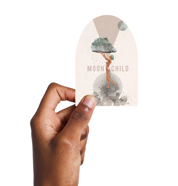 Model's hand holds the Moon Child sticker for size reference