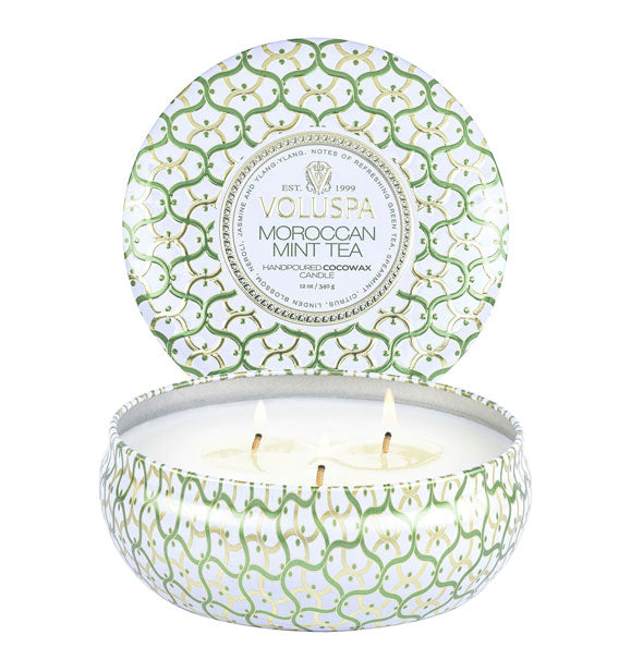 Green and white decorative Voluspa Moroccan Mint Tea candle tin with three burning wicks