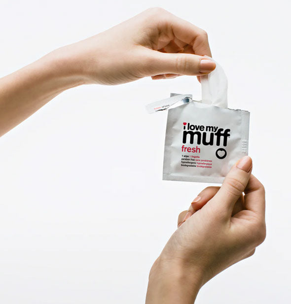 Model tears removes an I Love My Muff Fresh Wipe from a torn-open packet
