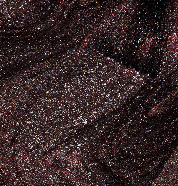 A swatch sample of deep, shimmery, burgundy-black OPI My Private Jet nail polish.