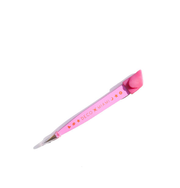 Small pink tweezer with pointed tip and pink silicone top is printed with the Deco Miami logo in orange
