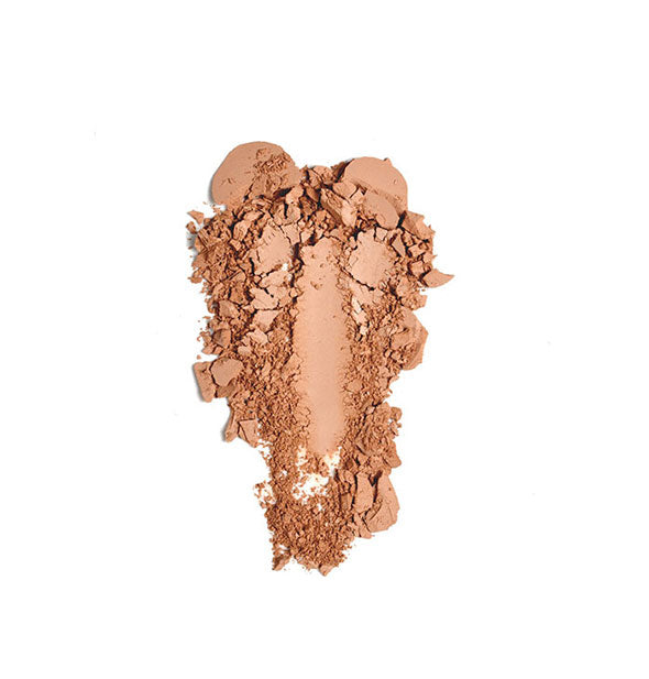 Crushed makeup powder in a peachy tan shade