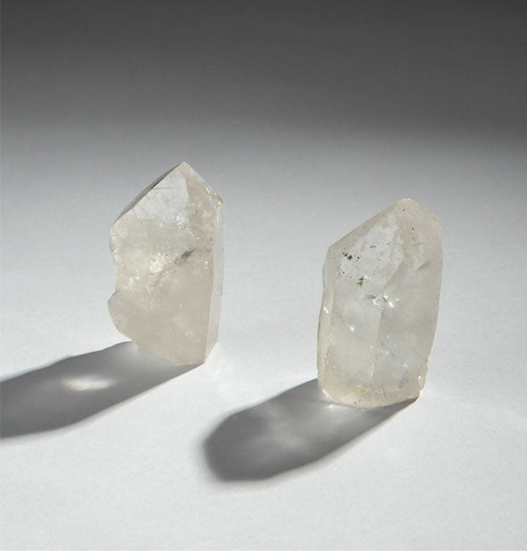 Two pieces of clear quartz crystal with shadows