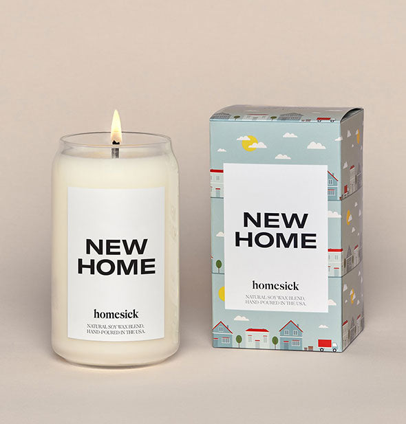 Clear glass New Home Candle by Homesick next to decorative box packaging