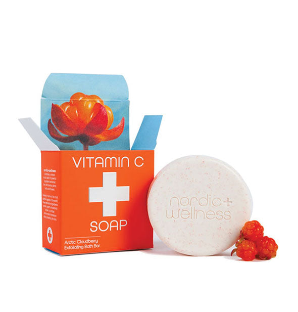 Round bar of Nordic+Wellness soap with orange box packaging and Arctic Cloudberry cluster