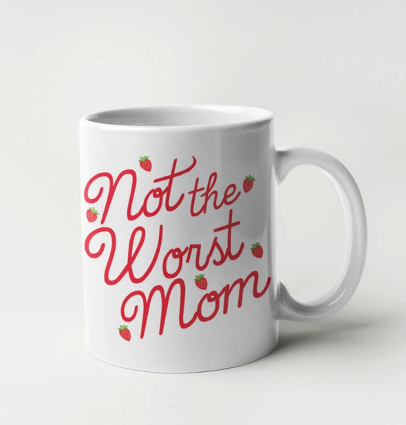 White coffee mug with red script that says "Not the Worst Mom" accented with tiny strawberries