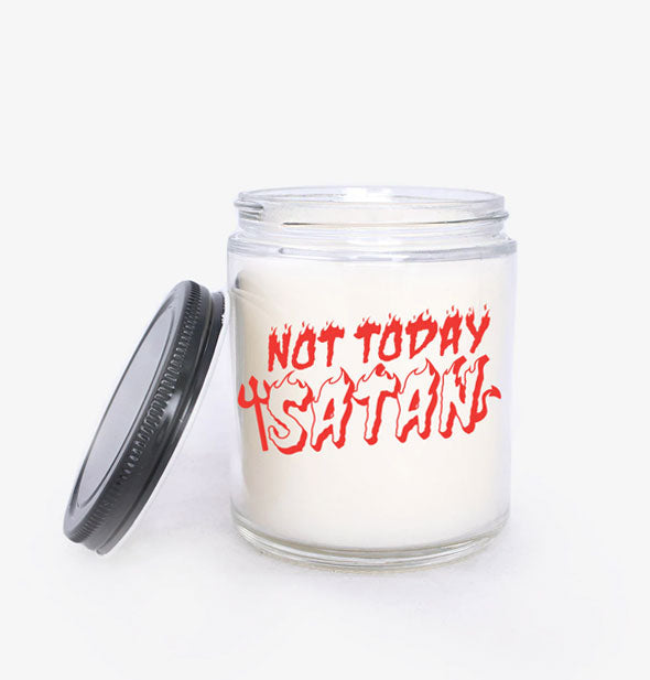 White wax jar candle with black lid says, "Not Today Satan" in a red flame font