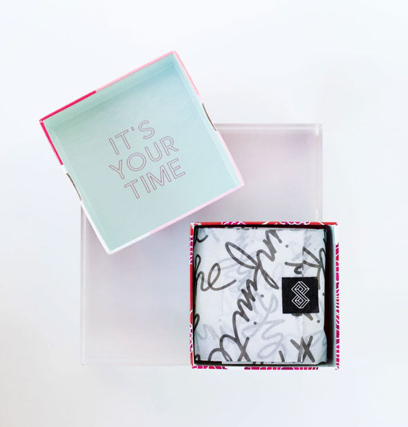 Bar soap box packaging with lid removed to show inside printed with, "It's your time"