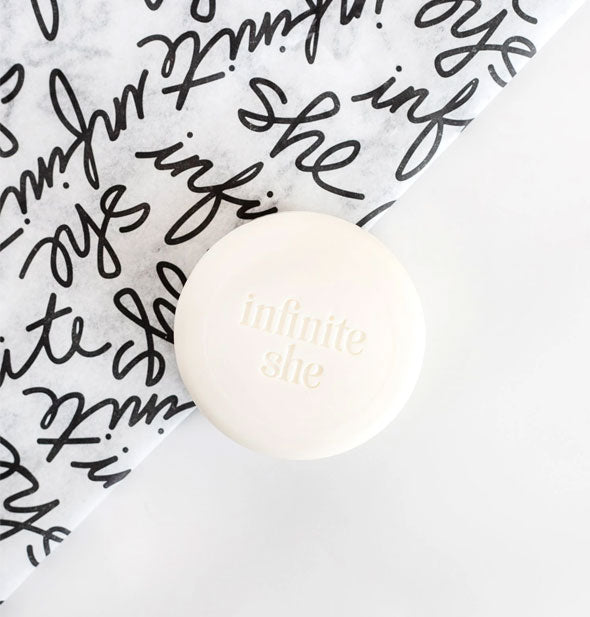 Infinite She round bar soap with script-covered tissue wrapper