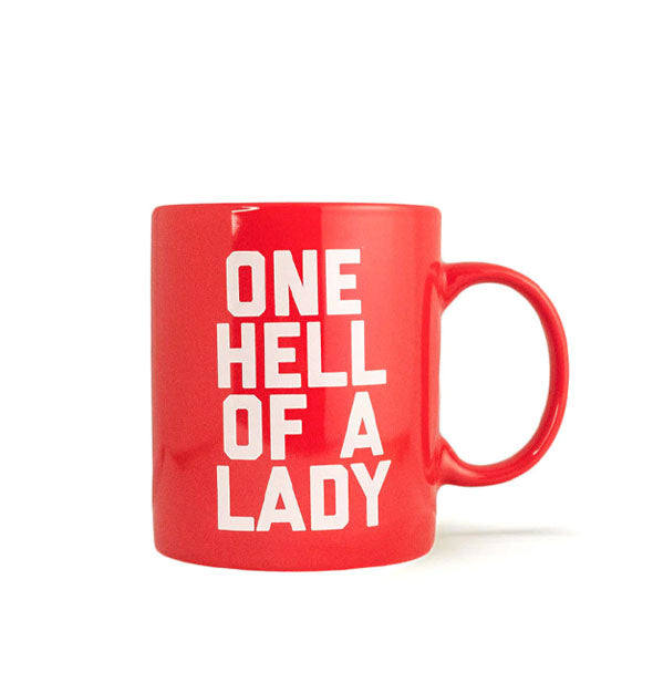 Red coffee mug says, "One Hell of a Lady" in white all-caps lettering