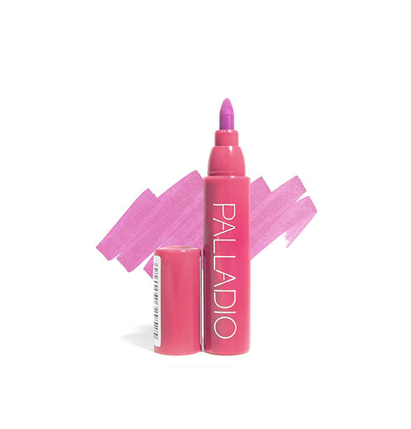 Pinkish-purple Palladio lip stain pen with cap removed and sample color swatch drawn behind