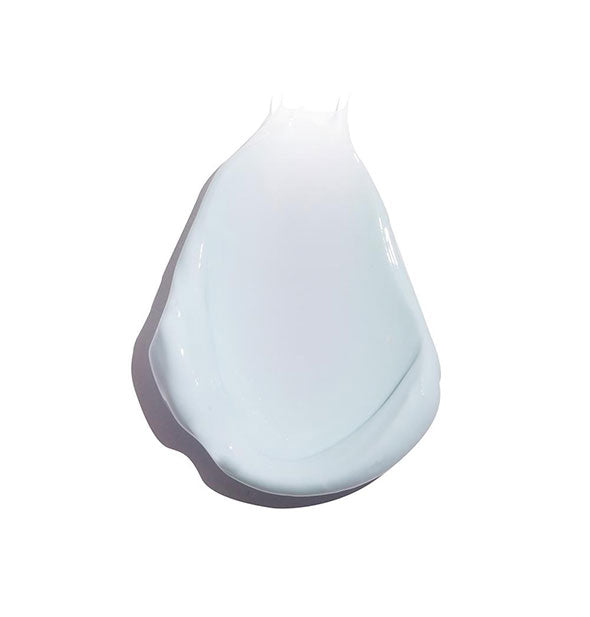 Sample daub of COOLA face sunscreen on white surface