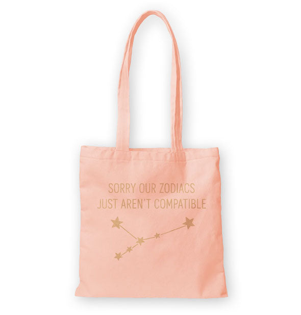 Pink tote bag with long handles says, "Sorry our zodiacs just aren't compatible" above a gold star constellation graphic