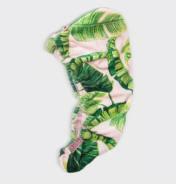 Palm leaf print microfiber hair towel wrap by Kitsch lays flat to show button closure and elastic opening