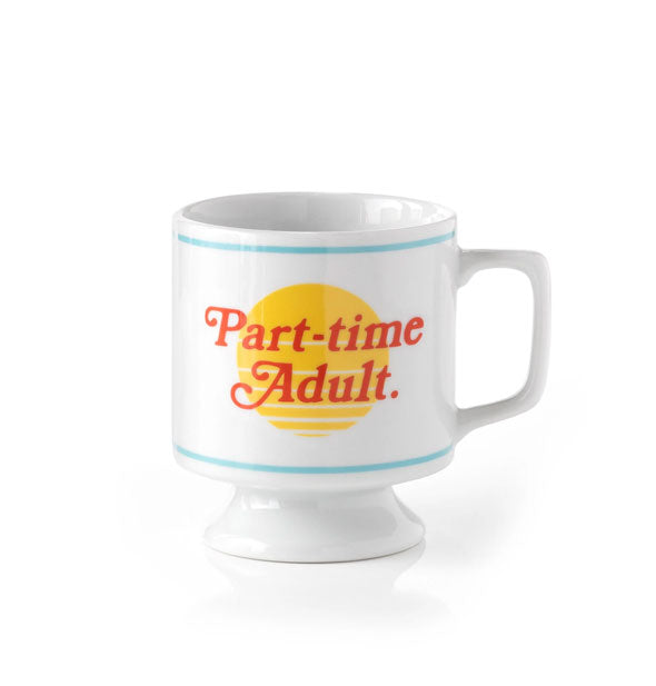 White coffee mug with pedestal shape features red, blue, and yellow artwork which says, "Part-time Adult."