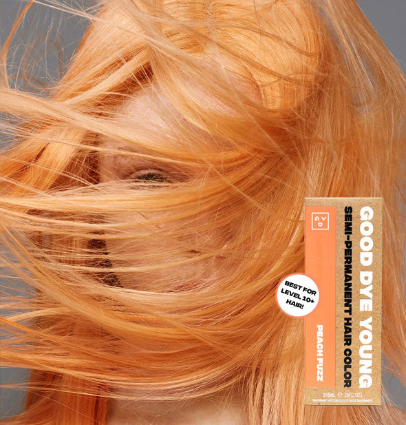 Model with bright pastel orange hair color by Good Dye Young in the shade Peach Fuzz