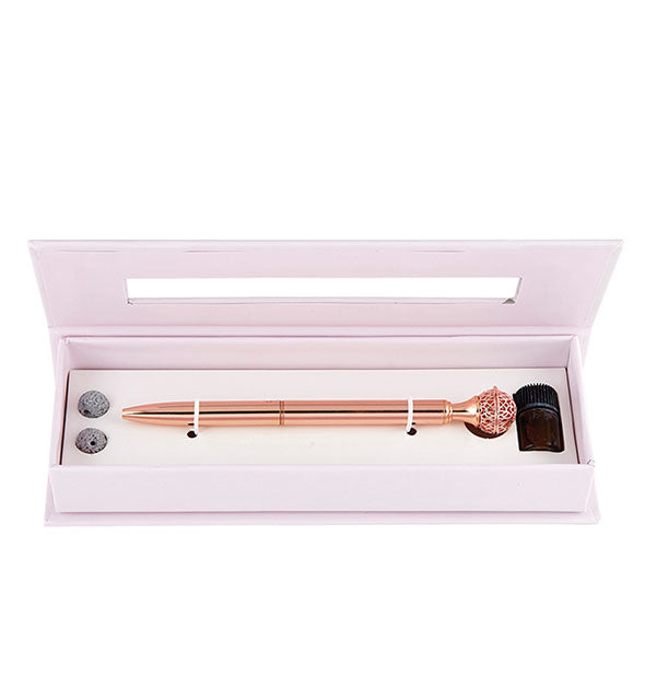 Peppermint essential oil diffuser pen in light pink box with lava balls and amber glass jar