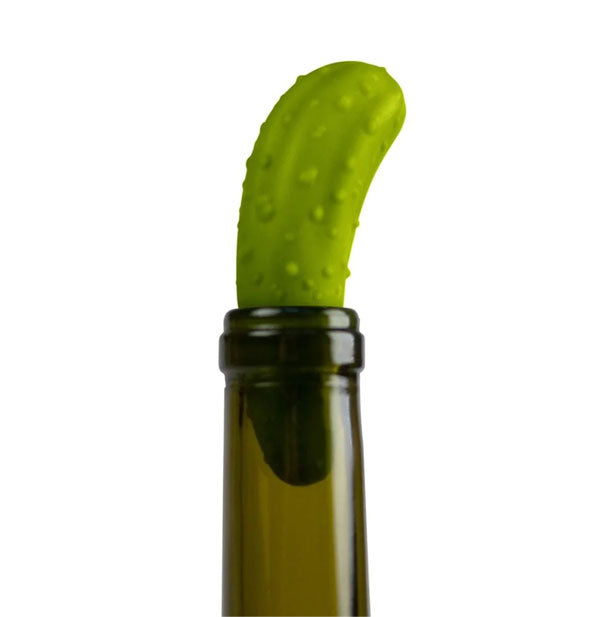 Green pickle bottle stopper shown corking the opening of a wine bottle