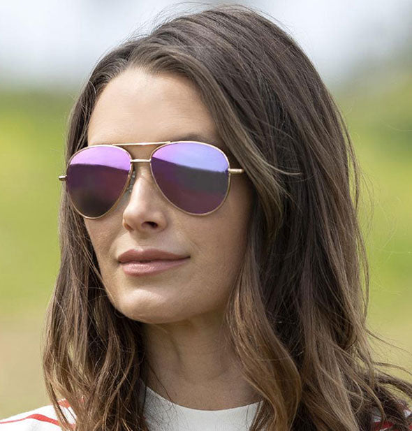 A model wears Peepers Heat Wave Polarized Sunglasses in Pink.