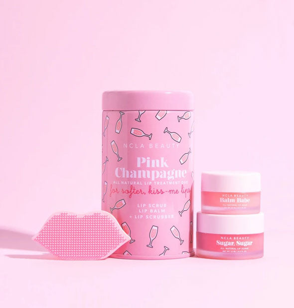 NCLA Beauty Pink Champagne Lip Care Duo tin with contents shown: two jars of product and one pink lip-shaped scrubber