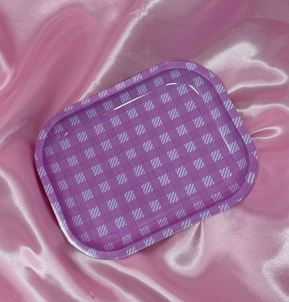 Rectangular tray with rounded corners and pink gingham pattern sits on a pink satin cloth