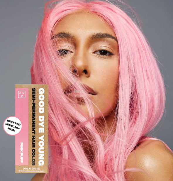 Model with bright pastel pink hair color by Good Dye Young in the shade Pink Puff