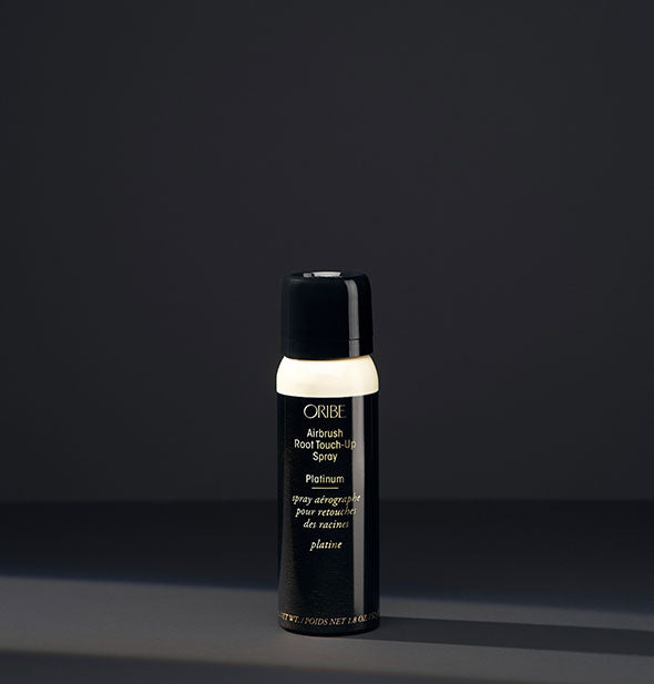 Small can of Oribe Airbrush Root Touch-Up Spray in the shade Platinum on a dark background