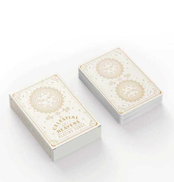 Deck of decorative playing cards and box with celestial sun motif