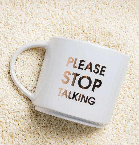 Please Stop Talking mug is partially buried in a pile of white sprinkles