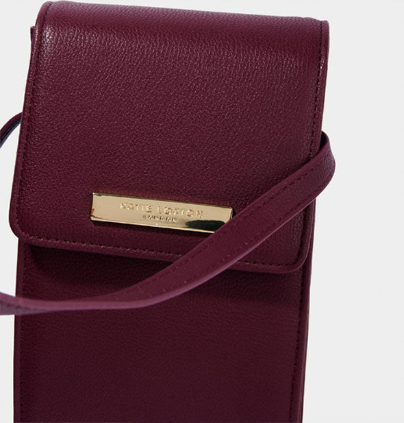 Closeup of Katie Loxton bag in plum color with metallic gold label