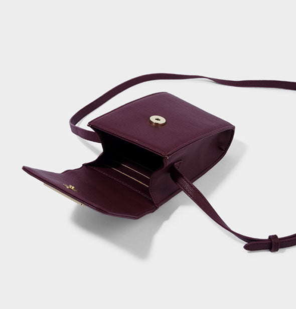 Open crossbody purse in plum color with gold button hardware and card slots inside